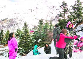 Tourists have fun in the fresh snow at Gulaba on the Manali-Rohtang road, about 21 km from Manali