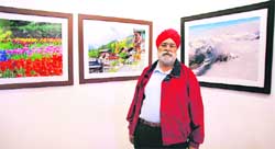 Satwan Singh Nandra, amateur photographer, with his exhibits at Artmosphere gallery in Ludhiana