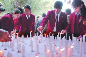 YOUNG FIGHTERS: Schoolchildren light candles while participating in Together for Peace, the nationwide youth campaign against terrorism, in New Delhi
