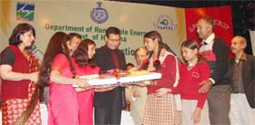 Haryana power minister Randeep Singh Surjewala presents energy-saving kits to schoolchildren in Gurgaon