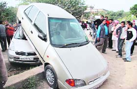 The driver of an Esteem car literally drove over an Alto near the mini secretariat in Ludhiana