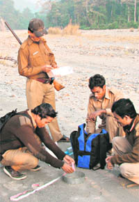 Forest officials measure tiger paw prints during the first day of a five-day-long tiger census at the Mahanada Wildlife Sanctuary, on the outskirts of Siliguri, on Thursday.