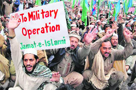Activists of Pakistan's hardline Islamic party Jamaat-e-Islami hold placards and party flags as they chant anti-US slogans during a protest in Peshawar on Thursday.