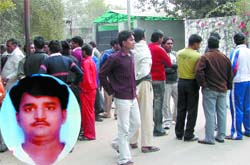 Friends and relatives of Ajay (inset), who was allegedly murdered by his uncle, gather outside a hospital in North Delhi on Friday.
