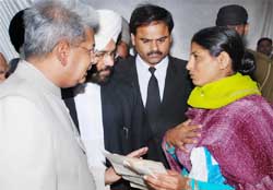 Justice Ajay Lamba of Punjab and Haryana High Court along with District and Sessions judge Kuldip Singh listening to the grievances of a litigant during the Mega Lok Adalat at Bathinda 