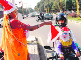 A roadside vendor sells Santa caps at Sectors 18-19 dividing road in Chandigarh.