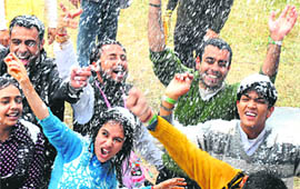 Children enjoy artificial snowfall at an amusement park in Panchkula on Saturday.