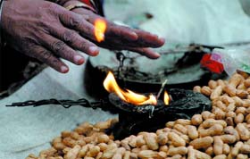 A peanut seller warms himself in New Delhi