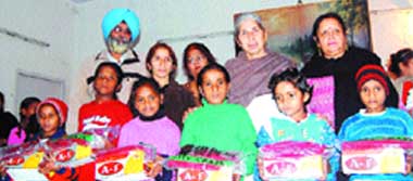 Health minister Laxmi Kanta Chawla distributes clothes and shoes to poor students of a government school in Amritsar 