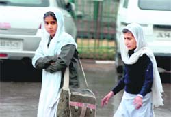 Students had to brave the cold commuting to school as heavy rain brought the mercury down in Jammu on Saturday.