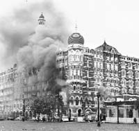 Smoke billowing out of Mumbais prestigious Taj Mahal hotel following the terrorist attack on November 26