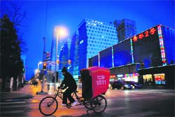 A pedicab driver rides through an intersection on a cold winter night in Beijing on Sunday. China urged local authorities to help find jobs for hundreds of thousands of migrant workers reported to be flooding home after being forced out of work by the global financial crisis, with the government warning provincial authorities the plight of migrant workers was a "pressing" issue as domestic companies are suffering from the crisis, according to a statement published on the cabinet's website. There are about 210 million migrant workers in China, according to official figures.  AFP