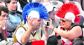 An English woman takes a picture of her partner at the stands
