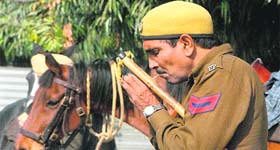A policeman lights a cigarette despite a ban on smoking at PCA Stadium in Mohali