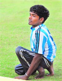 Dharma Singh Pal keenly waits for a ball at the boundary line during a match between India and England at PCA Stadium
