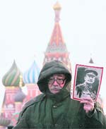 A Communist supporter holds Soviet dictator Josef Stalins portrait during a wreath-laying ceremony to mark his birth anniversary in Moscow. 