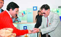 Uttarakhand health minister Dr Ramesh Pokhriyal Nishank hands over the key to a buyer at General Motors in Dehradun