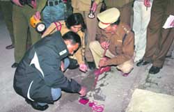Forensic experts and police officers examine the site of blast in Rohtak