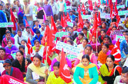 CPM workers stage a dharna at Mandi zonal hospital on Monday.