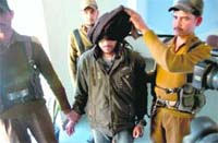 Cops take away HuJI chief Muzaffer Ahmed Illahi Daanger arrested in Jammu on Monday.