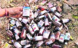 A heap of empty bottles of cough syrups in a park