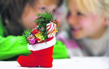 Children wait at a special Christmas post office for the appearance of a man dressed as Father Christmas in the village of Himmelpfort (Heaven's Gate), north of Berlin. The German postal service is offering a special Father Christmas office for post mails from children from all over the world until December 24. More than 256,000 letters from 80 countries were sent to Himmelpfort and have received replies in 15 languages. 