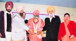 Sant Balbir Singh Seechewal being awarded at an NSS camp in Anandpur Sahib