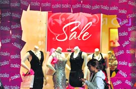 A woman walks past a store at a shopping mall in Glendale, California, on Tuesday. California Governor Arnold Schwarzenegger last week refused to sign an $18 billion deficit-reduction plan passed by California lawmakers and issued an executive order requiring state employees to take two unpaid offs every month. 
