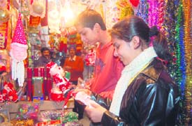 Shoppers buy Santa Claus toys at a shop