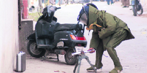 A member of a bomb disposal squad tries to find out whether a suitcase contains an explosive on the Kunjpura road in Karnal on Wednesday.