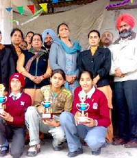 Students of Dasmesh Girls School, Badal, along with their trophies pose with the principal and other members of the staff.