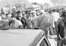 A VIP vehicle passes through a sea of devotees near Gurdwara Fatehgarh Sahib