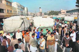 Protesting traders block a road in the Sirsa grain market
