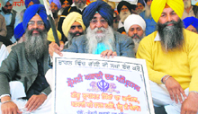 Akali Dal (A) leader Simranjit Singh Mann with supporters sits in dharna to seek ban on capital punishment at the Jor Mela in Fatehgarh Sahib on Wednesday.