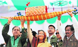Former Bangladesh Prime Minister and chief of the Awami League party Sheikh Hasina Wajed (centre) holds up the party symbol, a boat, with other officials during an election rally in Dhaka on Thursday. The nation will hold its first elections in seven years on December 29.
