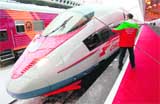 A railroad man cleans a window of German Siemens AG-made Velaro series high speed train named Sapsan before an inaugural ceremony in St. Petersburg