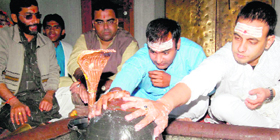 Cricketer Amit Mishra performs rituals at a temple in Haridwar on Friday.