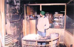 Avtar Singhs son Ranjeet Singh looks at the ruins of his shop after it was gutted in Ludhiana