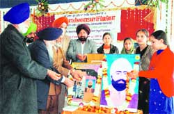 Members of the Shaheed Udham Singh Memorial Trust pay tributes to the martyr on his 109th birth anniversary at MGM Public School in Ludhiana