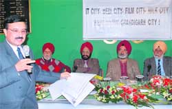 Social activist Hemant Goswami shows documents to highlight violations in finalising land deals for mega projects in Chandigarh