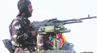 An Army jawan stands on a T-55 tank during an exhibition at Akhnoor, 28 km from Jammu, on Saturday.