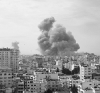 Smoke rises after an Israeli air strike in Gaza city on Saturday. Israeli war planes and combat helicopters pounded the Hamas-ruled Gaza Strip, killing at least 205 persons.