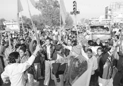 Agitated activists of various Hindu organisations block road at Tahli Wala Chowk in Rajpura on Sunday.