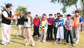 A golfer Manjit Kochar teaches the basics of the game in Panchkula on Sunday. 