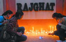 Students light candles at Rajghat in New Delhi on Sunday.