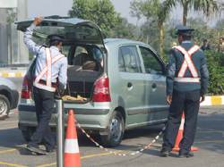 Security guards check a car at Cyber City, Ambience Mall in Gurgaon on Sunday.