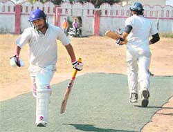 CN club batsmen cross over while taking a run in the District Cricket League match against DL Cricket Club in Dehradun on Sunday. 