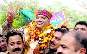 Party supporters lift state BJP president Ashok Khajuria after his election from Jammu East Assembly seat