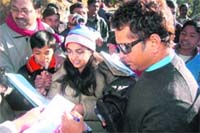 Sachin Tendulkar gives autographs to fans in Mussoorie.