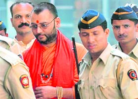 Malegaon blast accused Dayanand Pandey and Sameer Kulkarni (left) being taken to a court in Mumabi